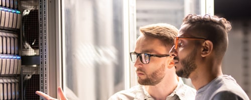 Two men looking at a computer server