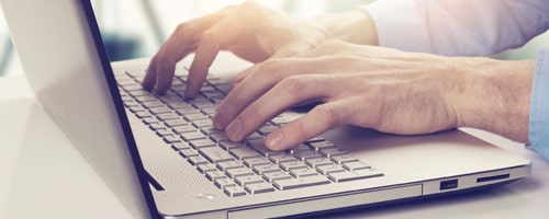 Man typing on Laptop